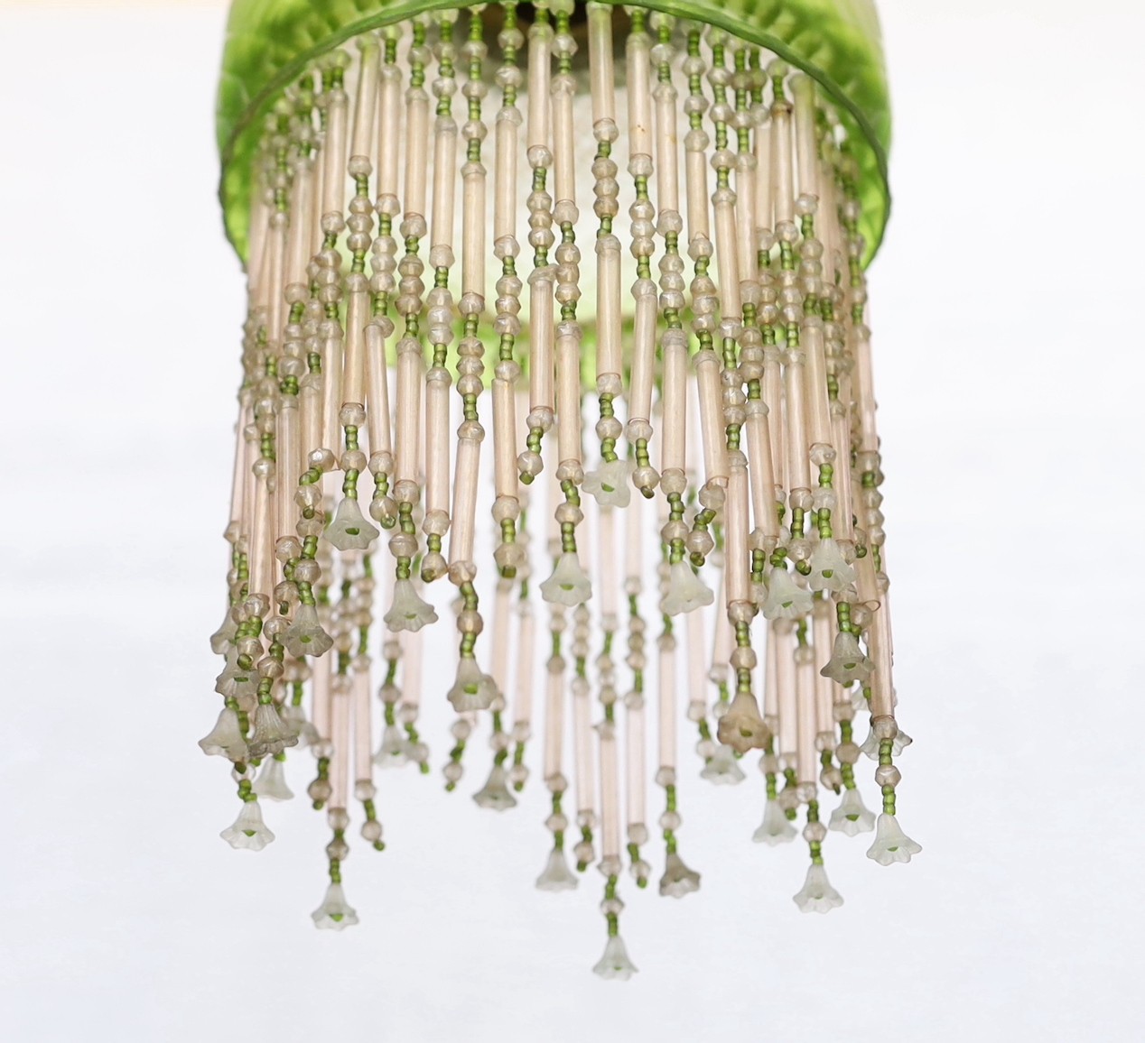 A 1920s French quilted glass light fitting with beaded fringe, height 30cm. width 15cm
